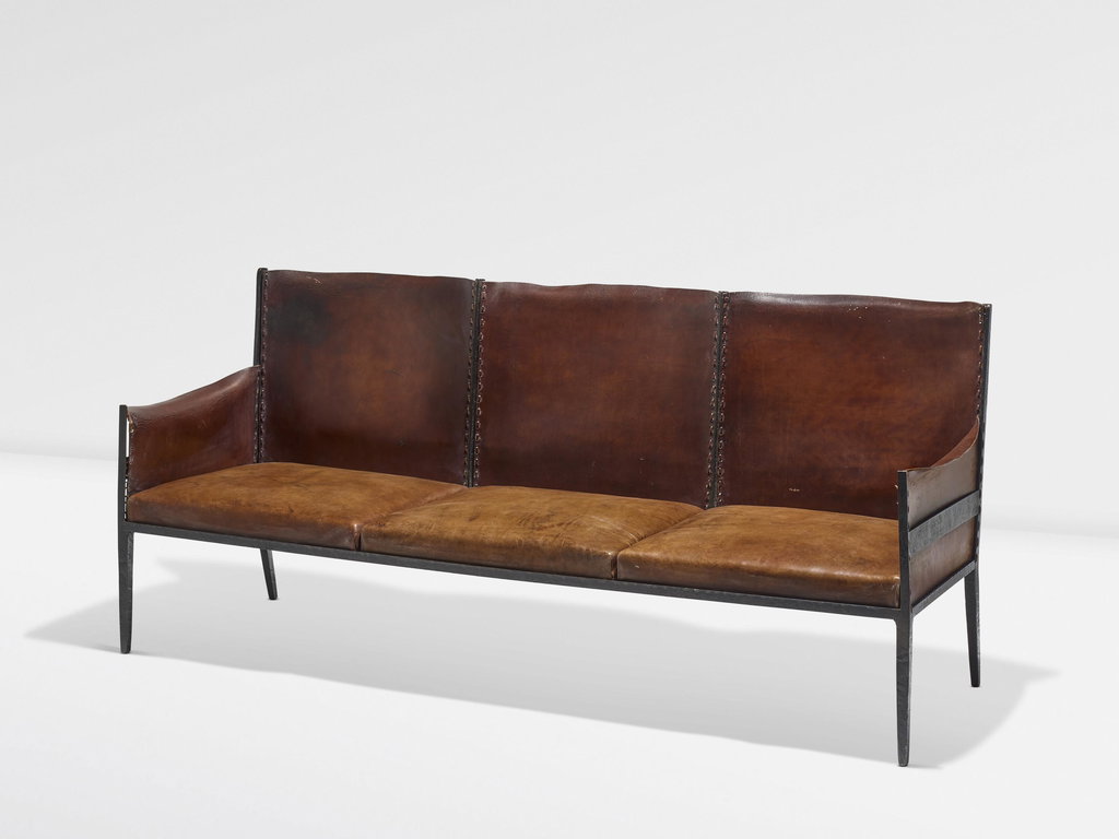 Sofa by Jean-michel Frank estimated at $469,400 (low) to $704,200 (high). Image courtesy of Christie's