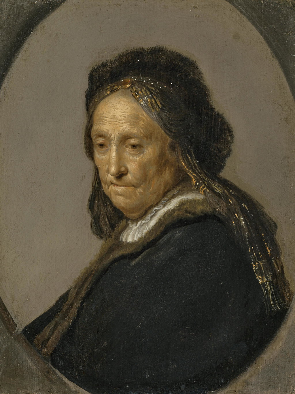 Head of an old woman, traditionally identified as Neeltgen Willemsdr. van Zuytbrouck (1569-1640), Rembrandt's mother, half-length, in a black costume with a fur hat, in a feigned oval. Image courtesy of Christie's