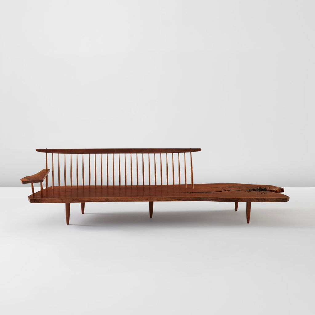 Rare and early "Conoid" bench with single free-form arm by George Nakashima sold for $180,600. Image courtesy of Phillips