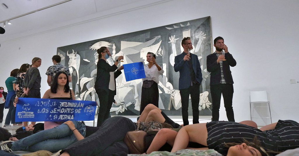NATO summit protesters play dead in front of Picasso war painting