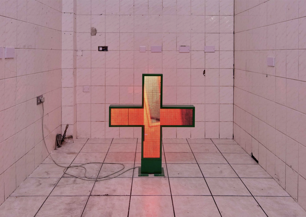 Racheal Crowther, Qualified to Care, 2022. Double-sided LED hijacked pharmacy sign, 6:47min video loop